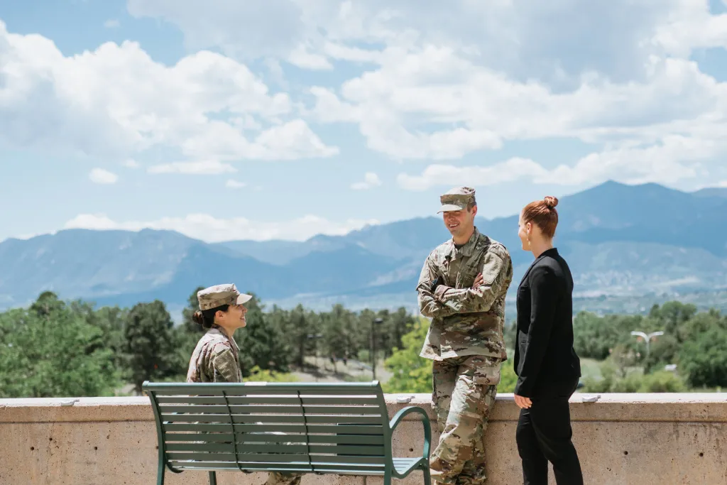 Military students in uniform talking outside on campus